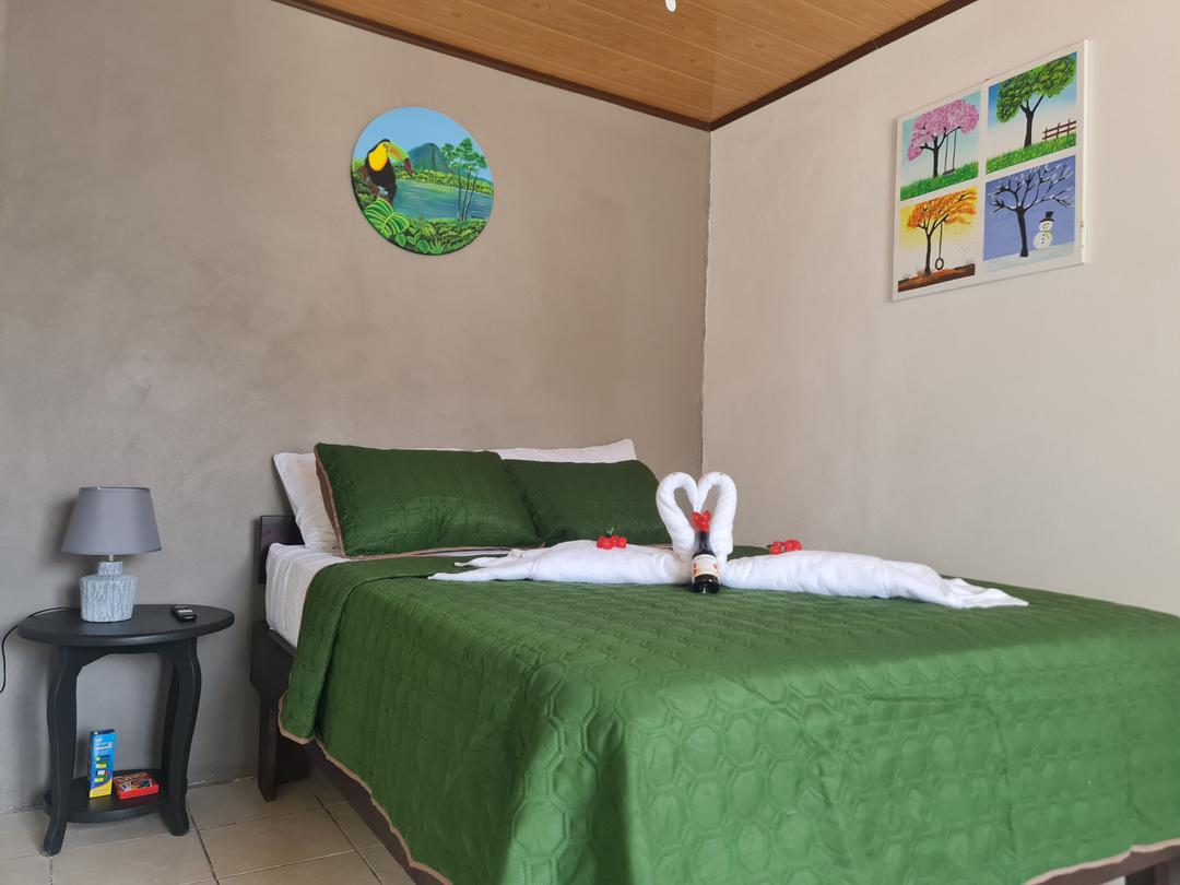 Spacious matrimonial bed in the living room of Guayabón Cabin 2, La Fortuna