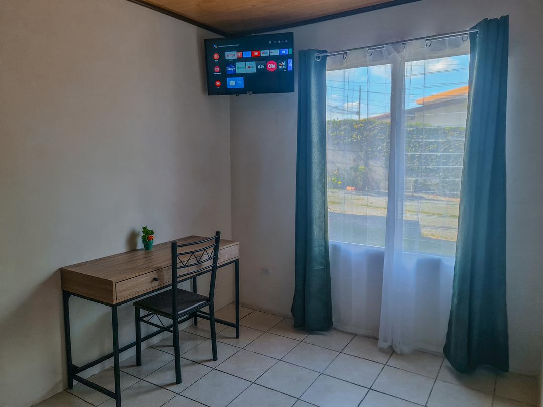 Spacious matrimonial bed in the living room of Guayabón Cabin 4, La Fortuna